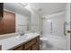 Bathroom featuring a vanity, toilet, and a shower over tub with accessibility features and handrails at 13890 E Marina Dr # 304, Aurora, CO 80014