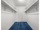Walk-in closet featuring blue carpet and white walls, maximizing storage and organization at 13890 E Marina Dr # 304, Aurora, CO 80014