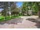 Apartment building exterior with lush landscaping and mature trees offering a serene community setting at 13890 E Marina Dr # 304, Aurora, CO 80014