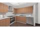 Bright kitchen featuring wood cabinetry, stainless steel appliances and white countertops at 13890 E Marina Dr # 304, Aurora, CO 80014