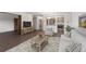 Cozy living room showcasing a stylish rug, furniture, and a glimpse of the kitchen at 13890 E Marina Dr # 304, Aurora, CO 80014