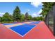 Brightly colored pickleball courts surrounded by lush trees and greenery offer a vibrant recreational space at 13890 E Marina Dr # 304, Aurora, CO 80014