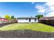 The large backyard features grass and mulch ground cover at 657 Locust Ave, Lochbuie, CO 80603