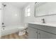 Clean, updated bathroom with modern vanity, fixtures and tiled shower at 657 Locust Ave, Lochbuie, CO 80603