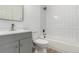 Bathroom with a white tiled shower and grey vanity at 657 Locust Ave, Lochbuie, CO 80603