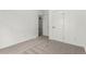 Bedroom showcasing carpet, white walls, and an open door at 657 Locust Ave, Lochbuie, CO 80603