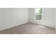 This is a bedroom featuring new neutral carpeting with a bright window at 657 Locust Ave, Lochbuie, CO 80603