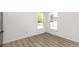 Cozy room with carpet flooring and double windows offering neighborhood views at 657 Locust Ave, Lochbuie, CO 80603
