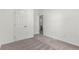 This bedroom has neutral carpet, white walls, and two doors at 657 Locust Ave, Lochbuie, CO 80603