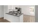 Updated kitchen with stainless steel appliances, sleek countertop, and hardwood floors at 657 Locust Ave, Lochbuie, CO 80603