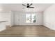 Inviting living room with sleek floors and large windows that provide natural light at 657 Locust Ave, Lochbuie, CO 80603