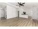 Bright, open living space with sleek floors, neutral walls, and a modern ceiling fan at 657 Locust Ave, Lochbuie, CO 80603