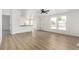 Sunny living room featuring sleek flooring, white walls and multiple windows at 657 Locust Ave, Lochbuie, CO 80603