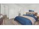 Cozy primary bedroom featuring a plush bed, accent rug, and en-suite bathroom access at 657 Locust Ave, Lochbuie, CO 80603