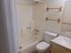 Bathroom with shower and tub, wood towel racks, and white sink at 1845 N Kendall St # 316D, Lakewood, CO 80214