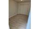 A cozy bedroom with light-colored vinyl floors and sliding closet doors at 1845 N Kendall St # 316D, Lakewood, CO 80214