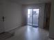 Living room with light-colored vinyl floors and a sliding glass door to a patio at 1845 N Kendall St # 316D, Lakewood, CO 80214