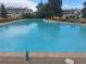 The community pool has lounge chairs and beautiful views of the community at 1845 N Kendall St # 316D, Lakewood, CO 80214