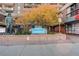 Brooks Tower building entrance with a statue, autumn tree, and clear signage at 1020 15Th St # 23L, Denver, CO 80202