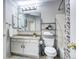 Bathroom featuring granite countertop, shower with patterned curtain, and shelving unit at 19804 Summerset Ln, Parker, CO 80138
