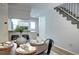 Cozy dining area with modern decor, staircase, and a view into the kitchen at 19804 Summerset Ln, Parker, CO 80138