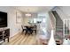 Open dining area with wood floors, modern light fixture, and staircase at 19804 Summerset Ln, Parker, CO 80138