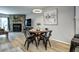 Stylish dining area with stone fireplace, hardwood floors and modern decor at 19804 Summerset Ln, Parker, CO 80138