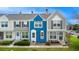 Charming townhome featuring a blue exterior, white trim, and well-maintained front lawn at 19804 Summerset Ln, Parker, CO 80138