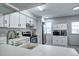Bright kitchen featuring white cabinets, stainless steel appliances and tile floors at 19804 Summerset Ln, Parker, CO 80138