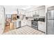 Bright kitchen features white cabinetry, stainless steel appliances, and tile flooring at 19804 Summerset Ln, Parker, CO 80138