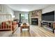 Cozy living room with stone fireplace and wood-look flooring at 19804 Summerset Ln, Parker, CO 80138