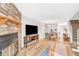 Open-concept living and dining area with stone fireplace and hardwood floors at 19804 Summerset Ln, Parker, CO 80138