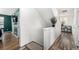 Hallway features wood-look flooring and a decorative plant at 10125 Zeno St, Commerce City, CO 80022