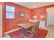 Cozy dining area with a rustic wooden table and a bright red accent wall at 148 Ambrose St, Erie, CO 80516