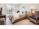 Bedroom with a comfy chair, large window, and a comfortable queen-sized bed at 237 Cherry St, Castle Rock, CO 80104
