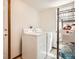 Convenient laundry room with full sized washer and dryer and shelving for storage at 237 Cherry St, Castle Rock, CO 80104