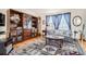Elegant living room with built-in shelving, a decorative rug, and ample natural light at 237 Cherry St, Castle Rock, CO 80104