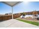 Relaxing back patio with a partial view of the backyard, featuring a well-maintained fence and landscaping at 195 Silver Rock Trl, Castle Rock, CO 80104