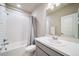 Bright bathroom with white tile, shower-tub, and gray vanity with white countertop at 195 Silver Rock Trl, Castle Rock, CO 80104