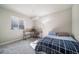 Cozy bedroom featuring neutral walls, carpet, a sunny window and a stylish desk area at 195 Silver Rock Trl, Castle Rock, CO 80104