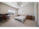 Bedroom with a large window for natural light, neutral carpeting, and ample space for a desk at 195 Silver Rock Trl, Castle Rock, CO 80104