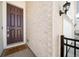 Close-up of a stylish front door with a welcome mat, complemented by a brick wall and sconce lighting at 195 Silver Rock Trl, Castle Rock, CO 80104