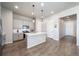 Well-lit kitchen featuring gray cabinets, stainless steel appliances, and pendant lighting over a central island at 195 Silver Rock Trl, Castle Rock, CO 80104