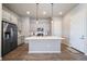Open kitchen with stainless steel appliances, a large island, and modern pendant lights at 195 Silver Rock Trl, Castle Rock, CO 80104