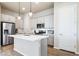 Modern kitchen with stainless steel appliances, gray cabinets, and a central island with pendant lighting at 195 Silver Rock Trl, Castle Rock, CO 80104
