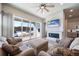Cozy living room with a fireplace, large glass doors to the backyard, and comfortable seating arrangements at 195 Silver Rock Trl, Castle Rock, CO 80104