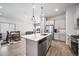 Open concept kitchen, dining, and living area with modern finishes and plenty of natural light at 195 Silver Rock Trl, Castle Rock, CO 80104
