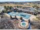 Aerial view of a community pool with covered pergolas and an in-ground hot tub at 195 Silver Rock Trl, Castle Rock, CO 80104