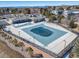 Aerial view of a community pool with clubhouse and mountain views in the background on a sunny day at 195 Silver Rock Trl, Castle Rock, CO 80104