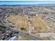Aerial view of a recreational area, with sports fields, open spaces, and a school in the background at 195 Silver Rock Trl, Castle Rock, CO 80104